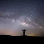 silhouette successful woman on the top of the hill on a backgrou